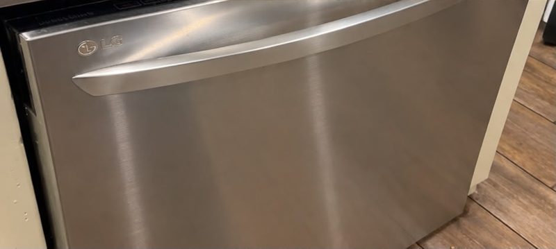 After cleaning: a stainless steel dishwasher front with streaks