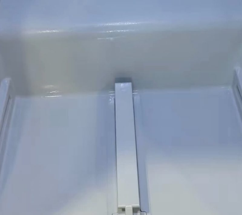 After cleaning: a refrigerator drawer with crumbs and residue